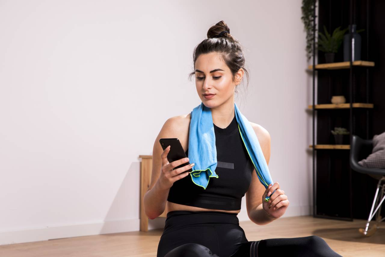 Fitness Woman Using Mobile Phone